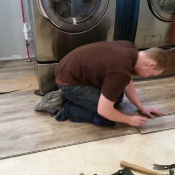 person installing laminate flooring